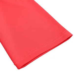 Close-up of vibrant red dress sleeve showing fine texture and neat double stitching