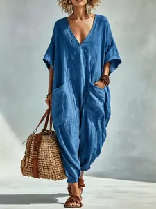 Detail view of loose blue cotton linen jumpsuit with large front pockets.