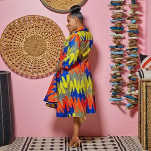 Vibrant African print dress with lapel collar and slim fit, shown on model.
