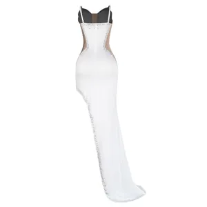 Detailed back view of a sexy white evening gown featuring sparkling rhinestones and mesh