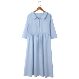 Macro detail of light blue cotton linen dress with buttons and collar