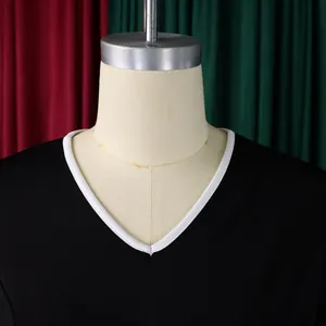 Close-up detail of the elegant V-neckline with contrasting white trim on a black dress
