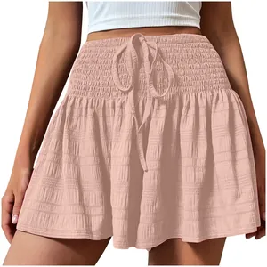 Close-up detail of women's smocked high waist pink summer shorts with drawstring