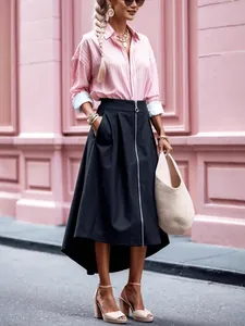 Full-length detail of a dark asymmetrical midi skirt with front zipper and side pockets