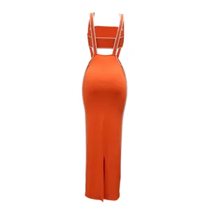 Back view detail of bright orange two-piece crop top and maxi bodycon skirt set with white trim