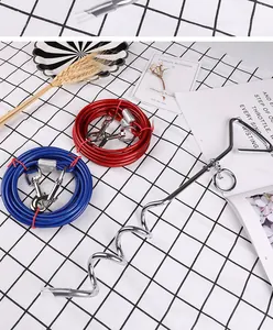 Detailed shot of heavy duty silver spiral dog tie-out stake with red and blue steel cables