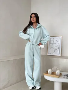 Full view of model wearing a light mint green two-piece zip-up hoodie and sweatpants set