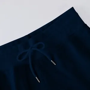 Close-up of navy high-waist elastic ribbed waistband with drawstring on lightweight pants