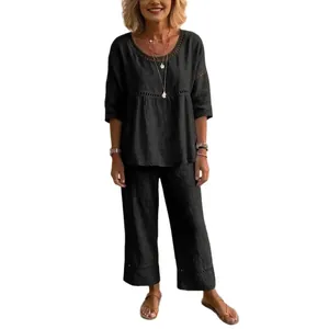 Women's loose black two-piece set in breathable linen-like fabric with lace details