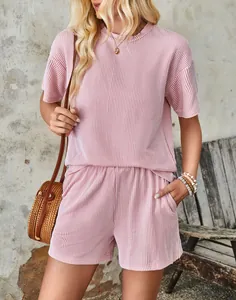 Casual pink two-piece set featuring wave textured short sleeve top and elastic shorts