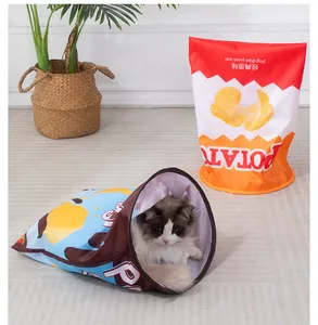 Ragdoll cat peeking out of a crinkle paper tunnel designed as a potato chip bag