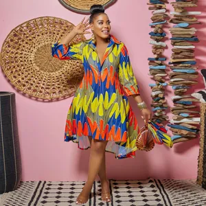 Detail view of vibrant African print midi dress with deep V-neck and high-low hemline