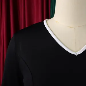 Close-up detail showing the white trim on a professional black V-neck elegant dress
