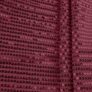 Close-up detail of burgundy sequin fabric with mesh backing for women's vest top