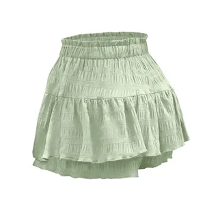 Dettaglio di una minigonna a pantalone verde salvia con volant e vita elasticizzata