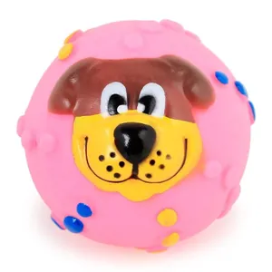 Close-up view of a pink squeaky dog toy ball featuring a cute cartoon puppy face design