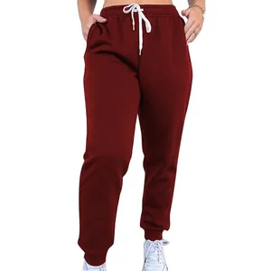 Detailed view of women's burgundy high-waisted jogger pants with white drawstrings