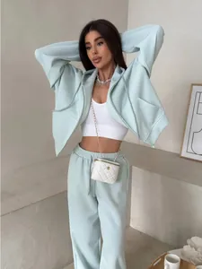 Two-piece mint green zip-up hoodie and sweatpants sports set with a white crop top