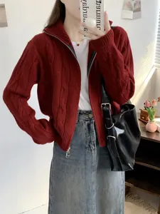 Detail of a red cable-knit zip-up cardigan with double zippers in a casual style.