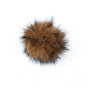 Soft faux fur pom-pom cat toy in brown and black for pet playing and enrichment