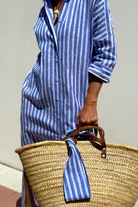 Blue striped button-down shirt dress styled with a large straw woven tote bag