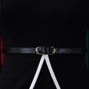 Close-up detail of the waist belt and white piping on a black elegant pencil dress.