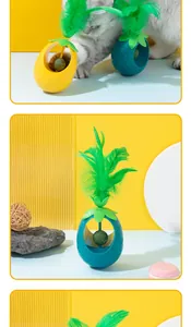 Detail showing pineapple-shaped catnip ball tumbler toy with green feather topper.