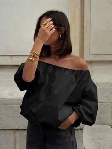 Elegant black off-shoulder puff sleeve blouse for a sophisticated summer commuter look