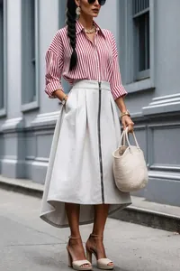 Detailed view of the front zipper and high-low hem on the chic irregular midi skirt.
