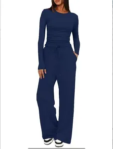 Detailed view of navy blue two-piece set with long-sleeve top and wide-leg drawstring pants
