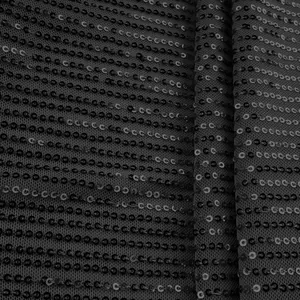 Detailed close-up showing the texture of black sequins on women's sleeveless tank top