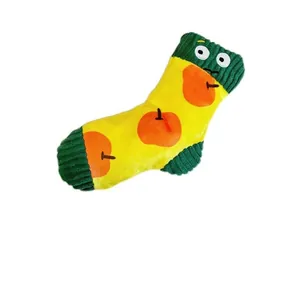 Detailed view of a yellow plush pet toy shaped like a sock with cute apple patterns.