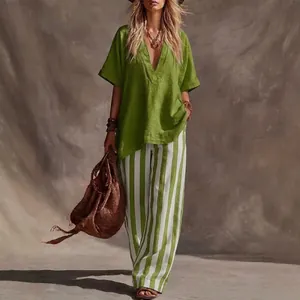 Stylish womens casual two-piece set featuring green V-neck top and striped wide leg pants.