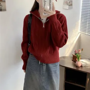 Chic woman wearing a red double zipper cable knit sweater for a cozy autumn winter look