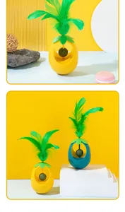Detailed view of a pineapple shaped catnip ball tumbler toy with vibrant green feathers