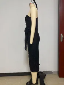 Detailed side view of a black sequin sleeveless cocktail dress on a professional mannequin