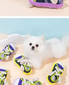 Close-up of colorful sneaker-shaped dog chew toy featuring durable cotton rope knots