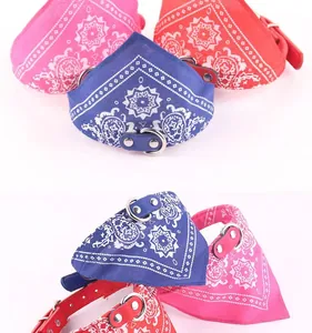 Close-up detail of colorful printed leather pet bandana collars with metal D-ring