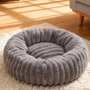 Soft plush round donut pet bed with grey ribbed texture for cats and small dogs in sunlit room
