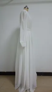 Vista laterale di un abito da sposa bianco con maniche a lanterna e tessuto perlato