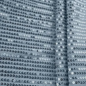 Close-up detail of silver sequin fabric texture on breathable mesh
