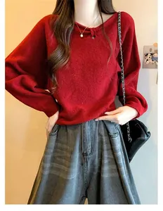 Close-up of a soft red batwing sleeve knit sweater with a unique pleated neckline design