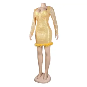 Macro detail view of the sparkling yellow sequin dress with a luxury feather hemline