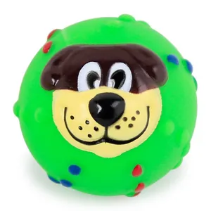 Detailed view of a green squeaky pet toy ball featuring a cute smiling cartoon dog face