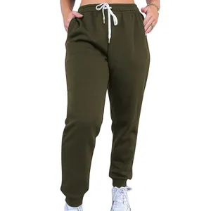 Close-up detail view of olive green high-waisted sweatpants with white drawstring waist
