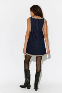 Detailed back view of a dark blue denim sleeveless dress with elegant beaded edging