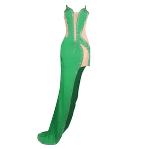 Sexy green sheer evening gown with rhinestones, high slit, and floor-length train detail.