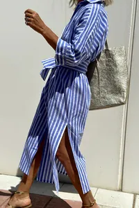 Detail of blue and white striped shirt dress with side slits and tie waist belt