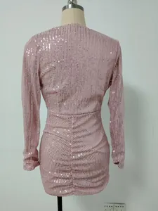 Back view of a pink sequin long-sleeved ruched party dress on a mannequin