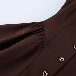 Close-up detail of a French retro brown sleeveless dress with elegant gold buttons